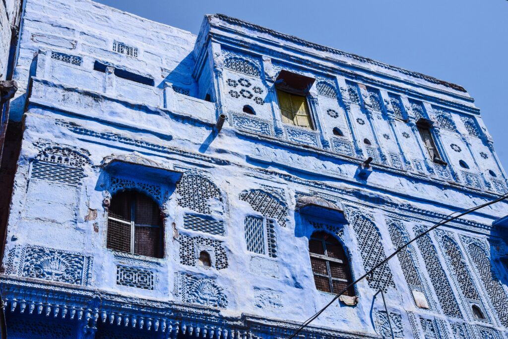 Intricate blue building facade in Jodhpur, showcasing traditional Indian architecture.