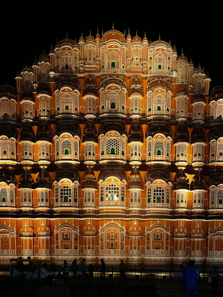 Stunning night view of Hawa Mahal in Jaipur, showcasing its intricate façade and vibrant lighting.