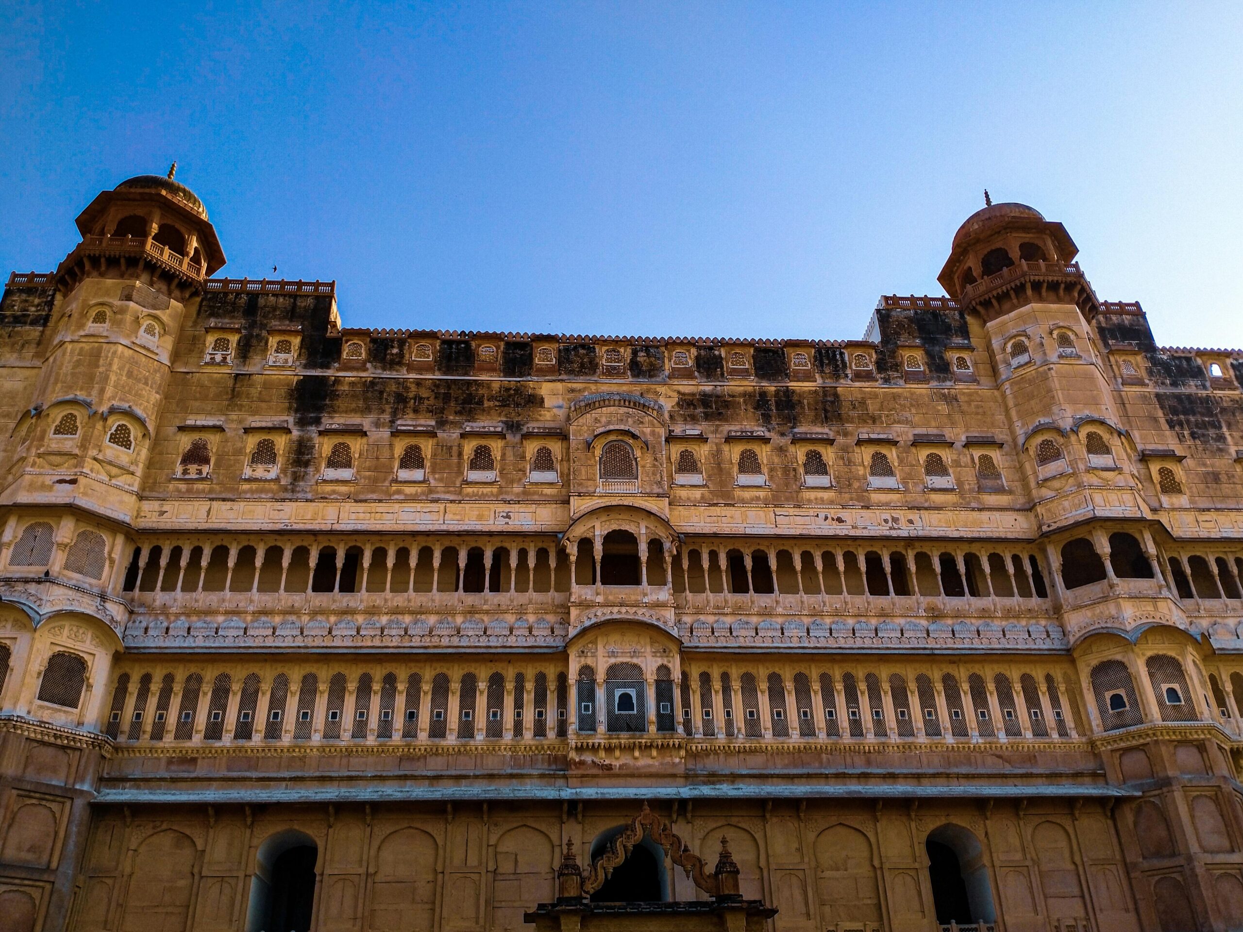 Beautiful facade of the historical Junagarh Fort in Bikaner, India, under a clear blue sky.